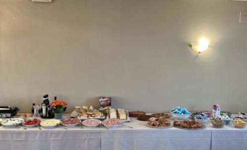 a table with many different types of food on it at Residence Marina di Cecina in Marina di Cecina