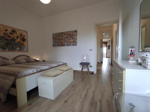 a bedroom with a large bed and a kitchen at Dimora Zoe sea view by CASASI Vacanze Otranto in Otranto