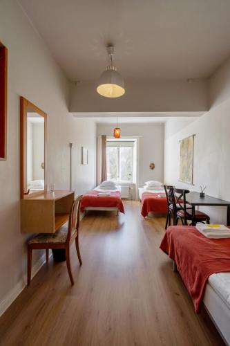 a room with two beds and a table and chairs at Reimersholme Hotel in Stockholm