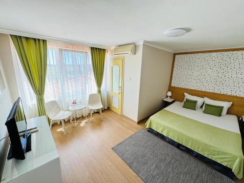 a hotel room with a bed and a television at Hotel Amfora in St. St. Constantine and Helena