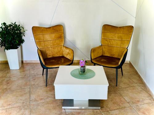 two chairs and a coffee table in a room at Hotel Amfora in St. St. Constantine and Helena