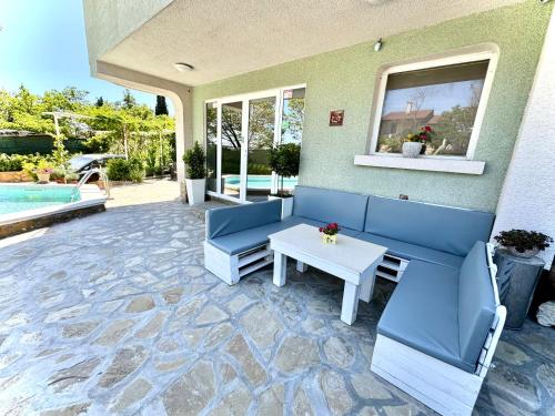 a patio with a blue couch and a table at Hotel Amfora in St. St. Constantine and Helena