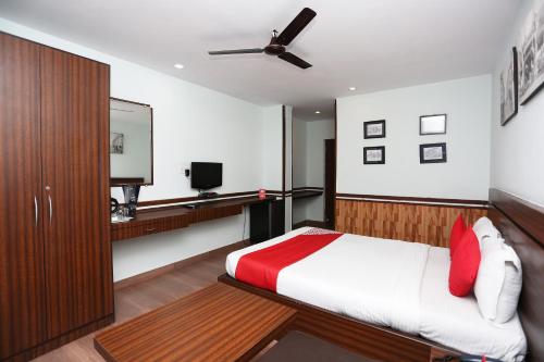 a bedroom with a bed and a television in it at Hotel O The Stay in Kolkata