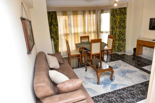 a living room with a couch and a table at Regency Hotel Alexandria in Alexandria