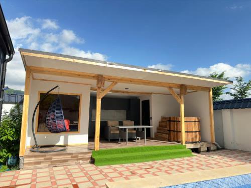 a building with a patio with a table and a grill at Qafqaz Suite Wood Stack in Gabala