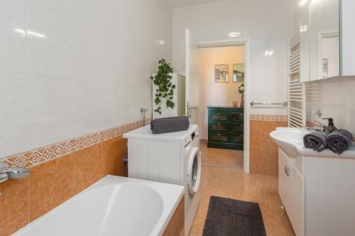 a bathroom with a washing machine and a sink at Apartment Oleandar in Poreč