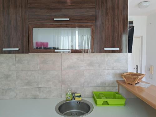 a kitchen counter with a sink and a mirror at Anthony in Niš