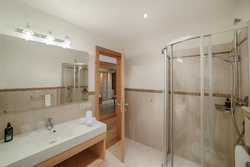 a bathroom with a sink and a shower at Hotel Alpenblick in Lutago