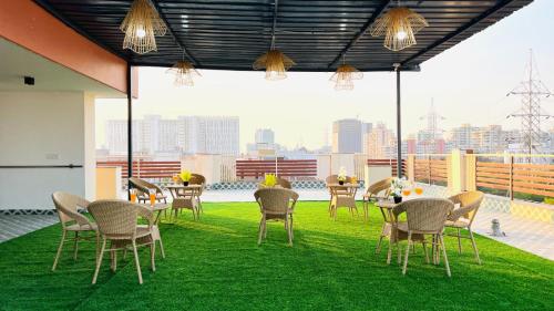 a restaurant with chairs and tables on a roof at BluO Medicity Hotel Medanta Hospital - Gurgaon in Gurgaon