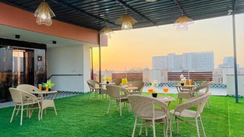 a restaurant with tables and chairs on a roof at BluO Medicity Hotel Medanta Hospital - Gurgaon in Gurgaon