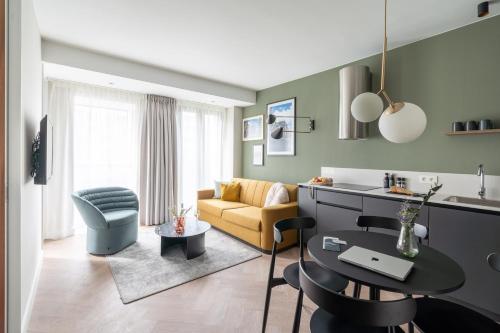 a living room with a couch and a table at YAYS Antwerp Opera by Numa in Antwerp