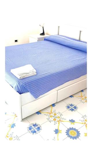 a bed with a blue and white bed frame at VILLA AZZURRA in Gaeta