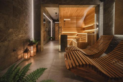 a hallway with two wooden benches in a building at Pensjonat Litworówka Wellness&SPA in Poronin