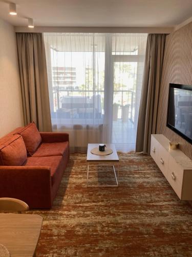 a living room with a couch and a tv at BEL MARE 2 F207 in Międzyzdroje