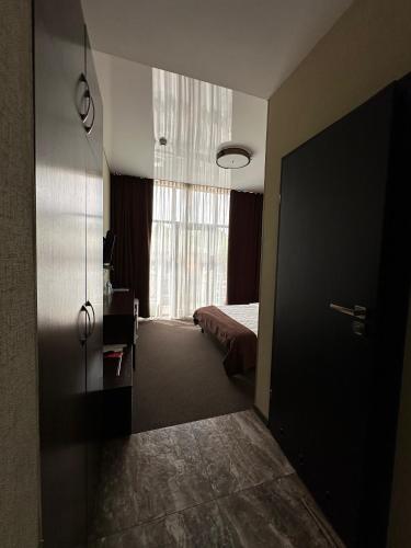 a hotel room with a bed and a window at Hotel Atmosphere in Poltava