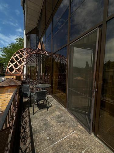 a balcony with a table and chairs on a building at Hotel Atmosphere in Poltava