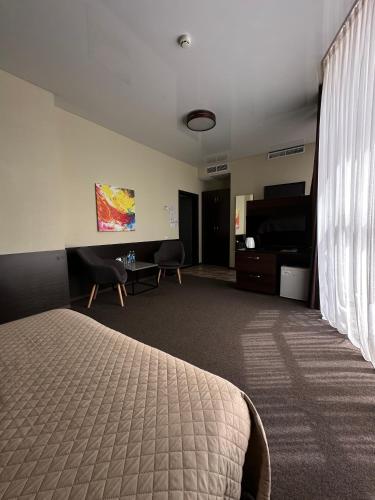 a hotel room with a bed and a desk at Hotel Atmosphere in Poltava