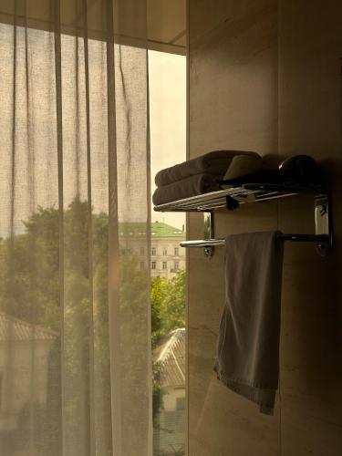 a bathroom with a window with a towel on a shelf at Hotel Atmosphere in Poltava