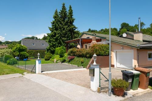 a house with a gate and a driveway at Relax apartma Peter in Ptuj