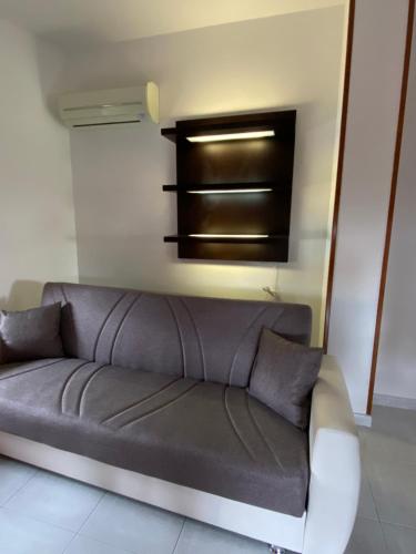 a gray couch in a room with a wall at Nonna Pippi in Oristano