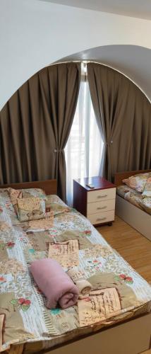a bed with pillows on it in a bedroom at апартамент CITY HOME 22 in Yambol