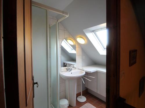 a bathroom with a sink and a skylight at Gîte Baugé en Anjou, 5 pièces, 9 personnes - FR-1-622-28 in Baugé