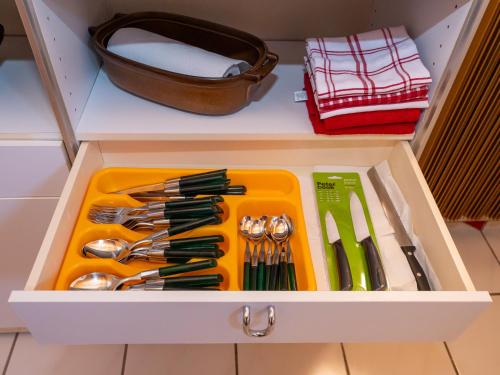 a drawer filled with utensils in a kitchen at Relax apartma Peter in Ptuj