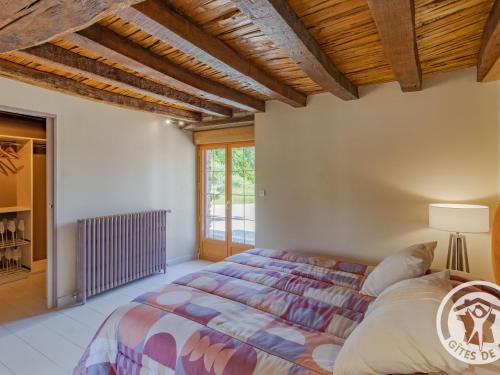 a bedroom with a large bed in a room at Gîte familial avec piscine privée, proche d'Angers et du Zoo de La Flèche - FR-1-622-65 in Baugé-en-Anjou