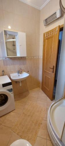 a bathroom with a sink and a toilet and a mirror at Adriatic - Apartment with jacuzzi in Sobra