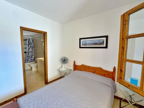 a bedroom with a bed and a large mirror at Villa Puig Rosell in Calonge