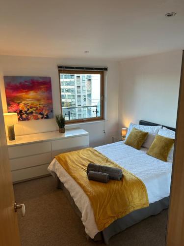 a bedroom with a large bed and a window at Stunning City Centre Water VIews 2 Bed 2 Bath FREE PARKING in Leeds