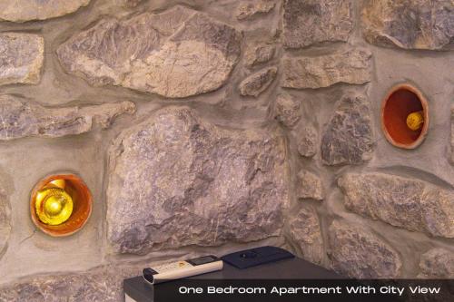 a stone wall with two orange vases on it at Villa Volos , free private parking in Opatija