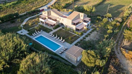 an aerial view of a house with a swimming pool at Abeloessa Methonian Hospitality in Methoni