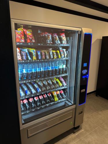 a refrigerator filled with lots of sodas and drinks at TIBET HOTEL am Airport Düsseldorf-Ratingen in Ratingen
