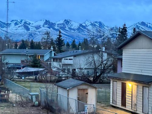 a group of houses with mountains in the background at Beautiful downtown Anchorage 4 in Anchorage