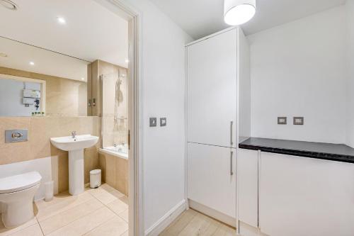 a bathroom with a toilet and a sink at The Railway Pass The Keys Modern 2-Bed Apartment in Central Altrincham in Altrincham