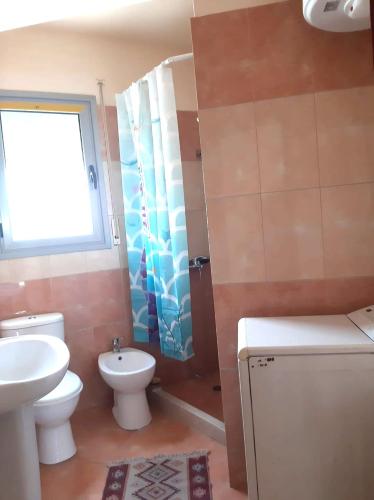 a bathroom with a sink and a toilet and a shower at Appartamento lungomare Bianca in Vlorë