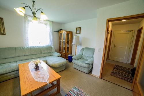 a living room with a couch and a table at Pension Arberwald in Bayerisch Eisenstein