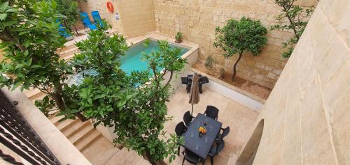 an overhead view of a pool in a building with trees at Dar Tan-Nanniet - House of Character with Private Pool in Żejtun