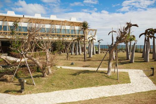 a park with trees in front of a building at Volando Kenting in Hengchun
