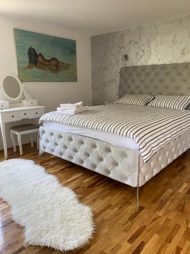 a bedroom with a large white bed with a white rug at Apartman17 in Belgrade