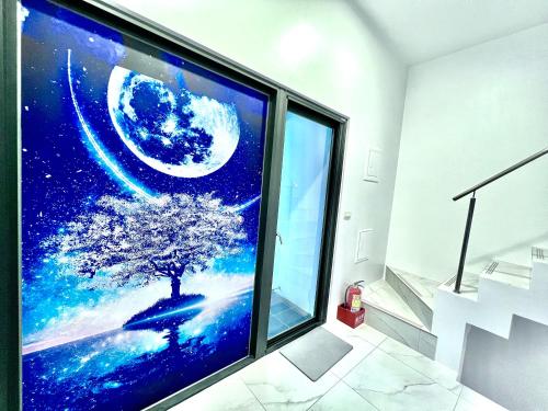 a large screen tv in a room with a tree at HHouse時尚會館 in Dongshan