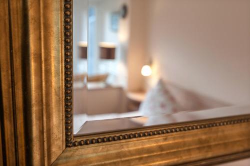 a mirror with a reflection of a room at Ferienhaus Meixner in Riedenburg