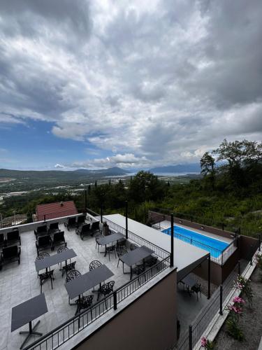 un balcón con mesas y sillas y una piscina en Residence Spa Apartments DUB, en Kotor