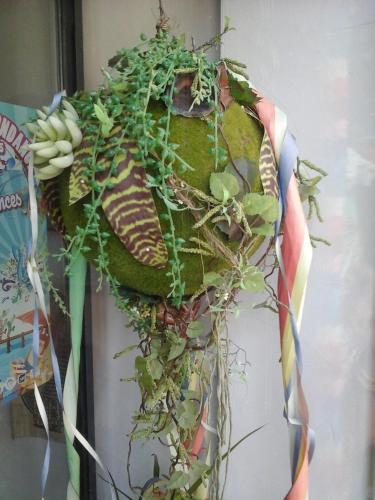 a potted plant is hanging on a wall at Hotel Du Centre in Hagondange