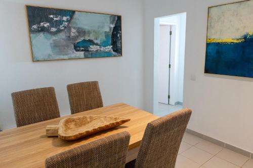 a dining room with a wooden table and chairs at Apartamentos - Solar Vale Covo in Carvoeiro