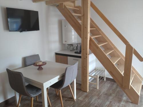 a kitchen and dining room with a table and a staircase at Casa do Pão in Campinho