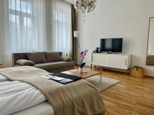 a living room with a bed and a couch at Burgblickhotel in Bernkastel-Kues