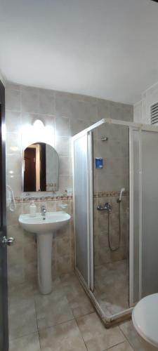 a bathroom with a shower and a sink at Bonapart Hotel in Çeşme