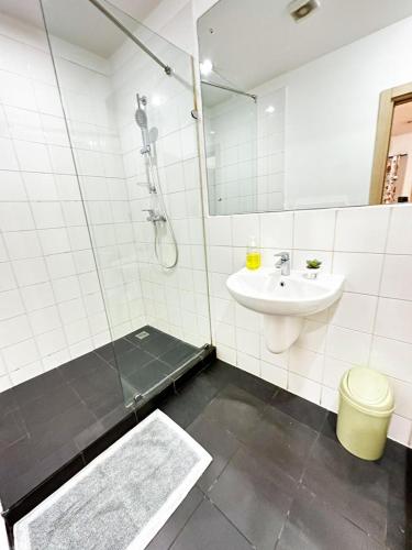 a bathroom with a shower and a sink and a tub at Gallery Apartments by BestWest Hospitality in Accra